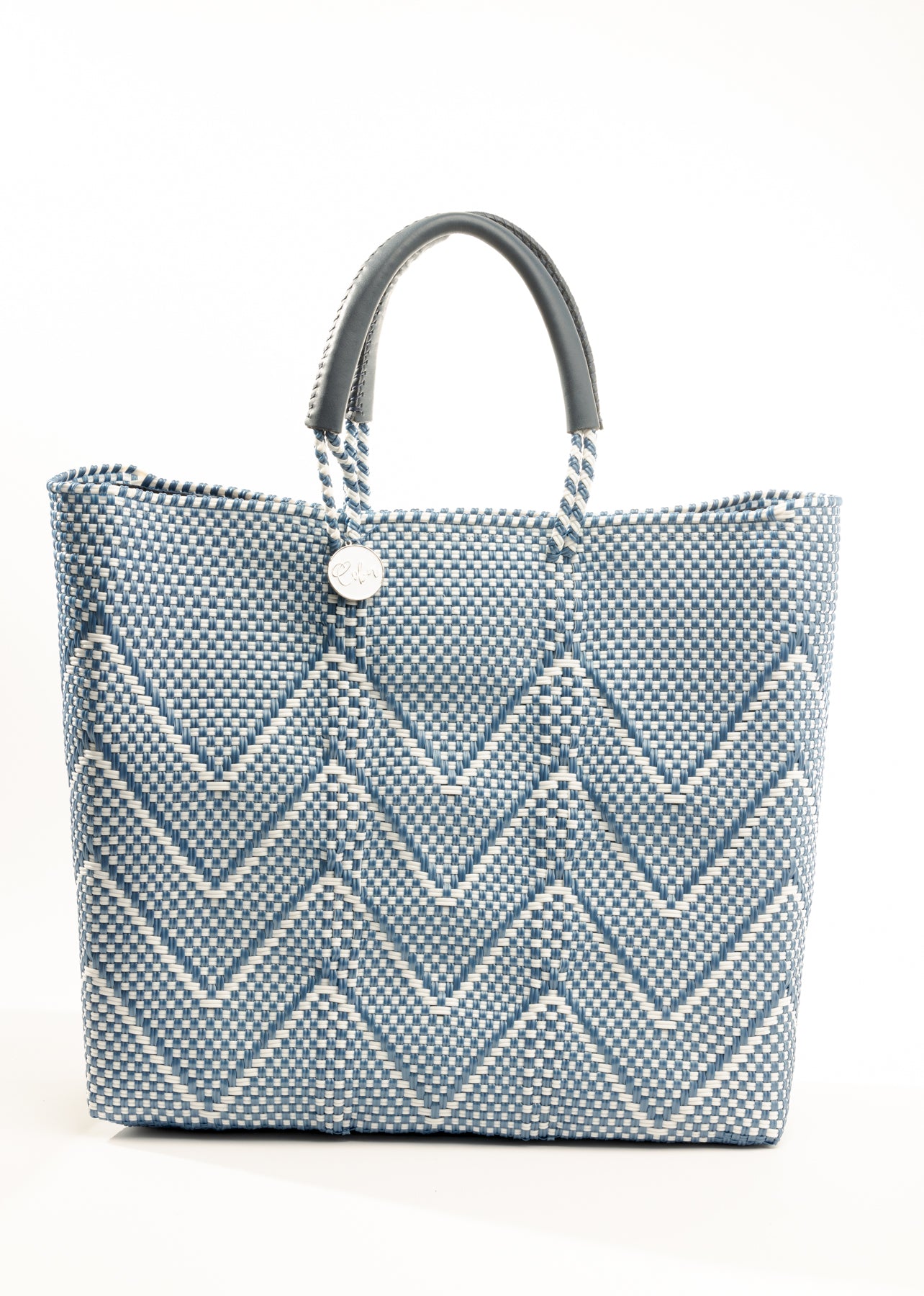 Blue and white chevron tote bag made from recycled plastics featuring a blue handle and silver Coba logo medallion
