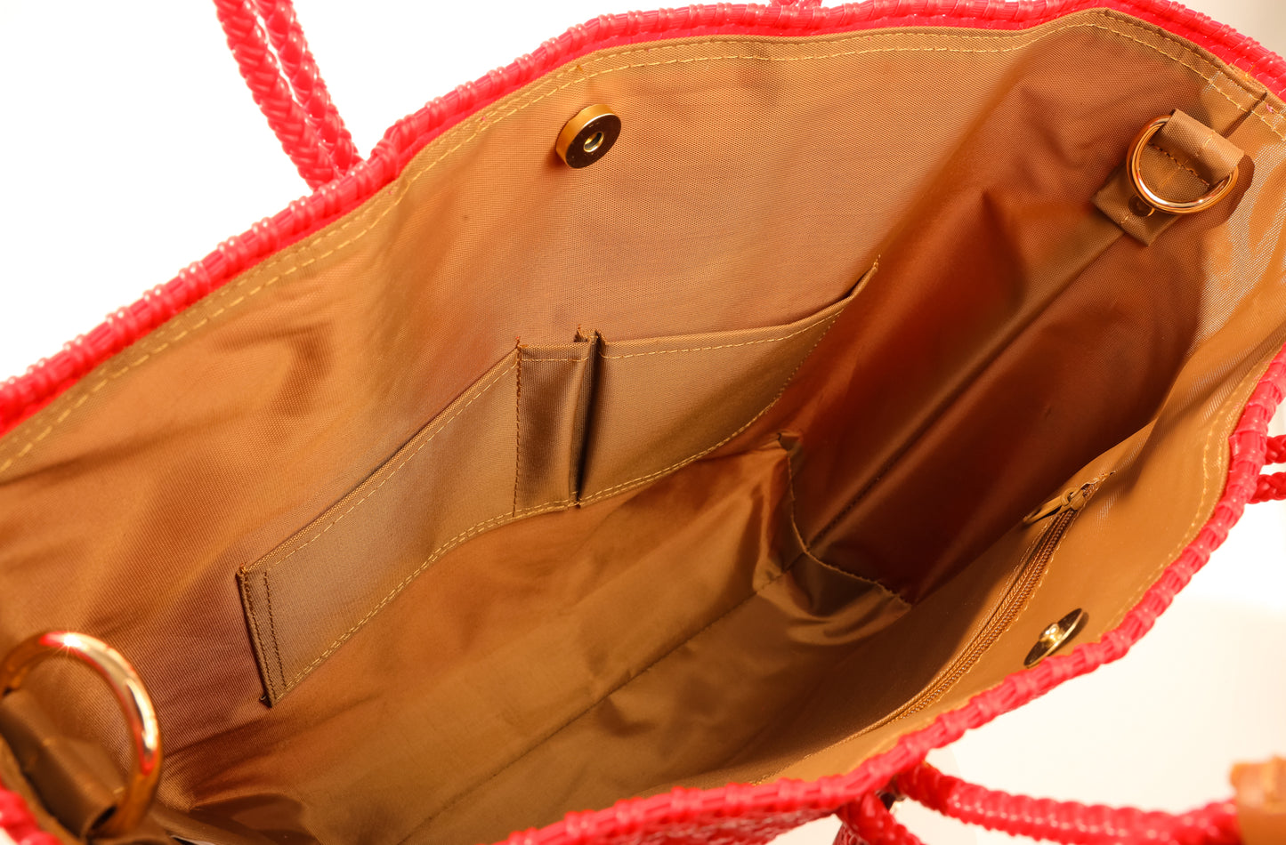 Tan lining with two pockets and magnetic closure of red woven bag made from recycled plastics